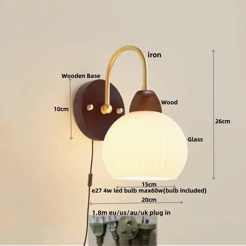 Modern gold and white glass wall lamp with warm spherical white glass, brass iron arm, and dark wood base