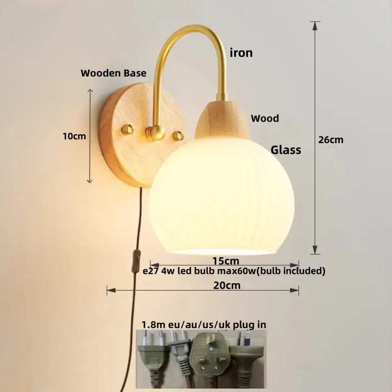 Modern gold and white glass wall lamp with warm-toned white glass globe, wooden base, and decorbites iron white arm