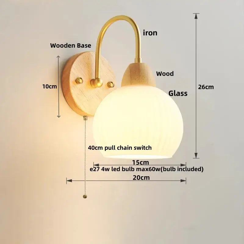 Modern gold and white glass wall lamp with warm-toned white glass globe, brass iron arm, wooden base, and 4w led bulb decorbites iron white
