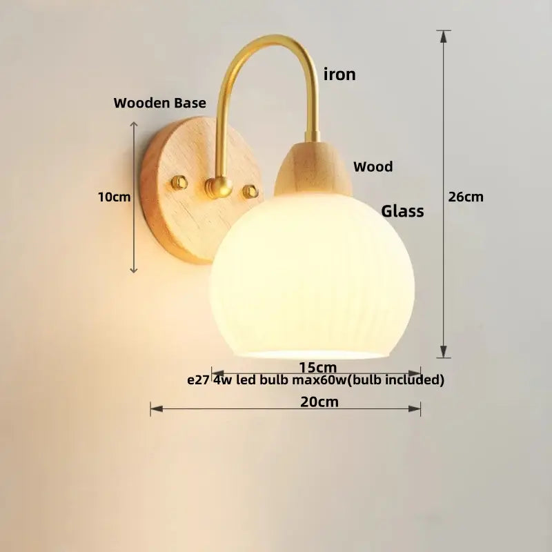 Modern gold and white glass wall lamp with warm-toned white glass globe, brass iron arm, and wooden base by decorbites iron white