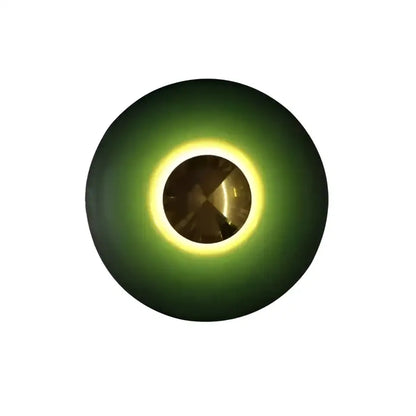 A sleek led ufo wall sconce with deep green ring and glowing yellow halo for bedside bedroom decor