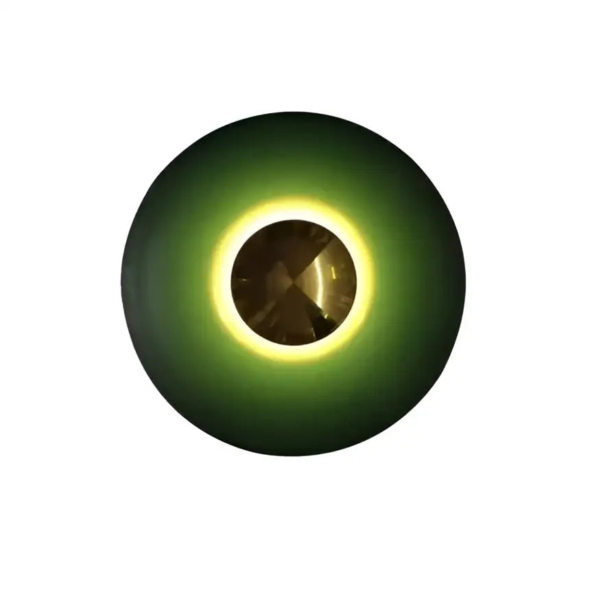 A sleek wall-mounted led ufo wall sconce with deep green ring and glowing yellow halo for bedside decor