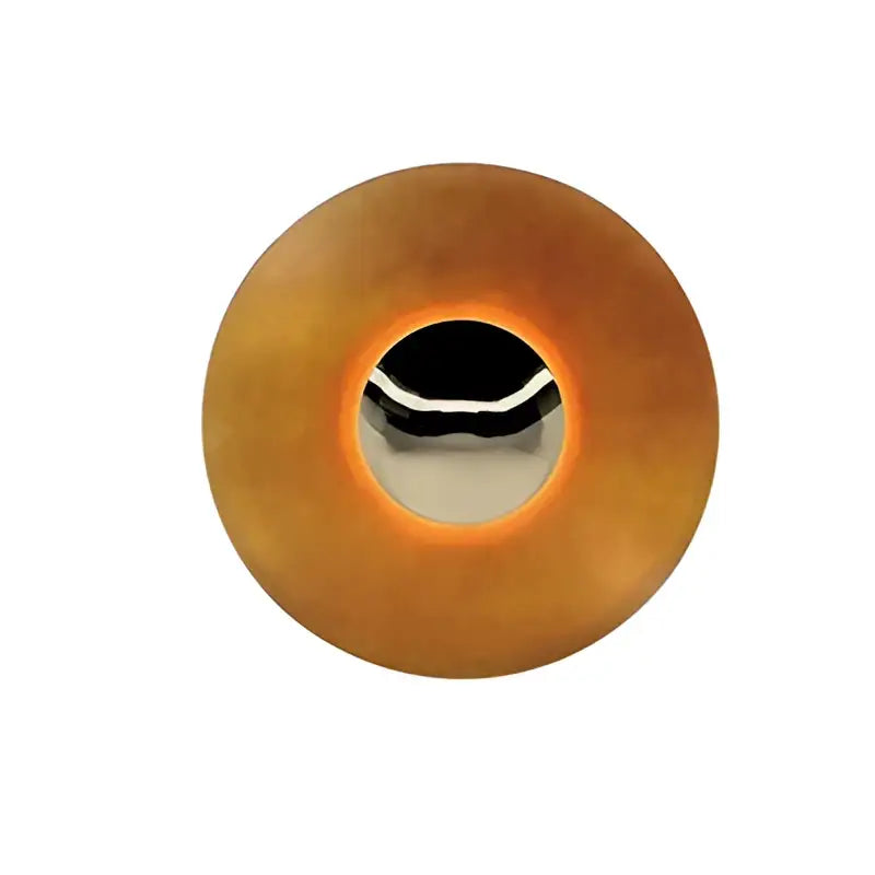 A circular amber plastic button with metallic hole and silver trim for modern gold and white led ufo wall sconces
