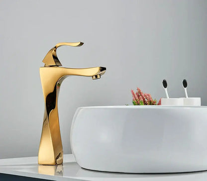 Modern gold angular basin faucet with waterfall design for bathroom decor featuring decorbites black bronze accents