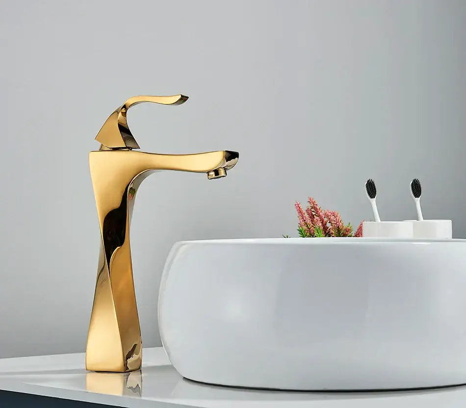 Modern gold angular basin faucet with waterfall design for bathroom decor featuring decorbites black bronze accents