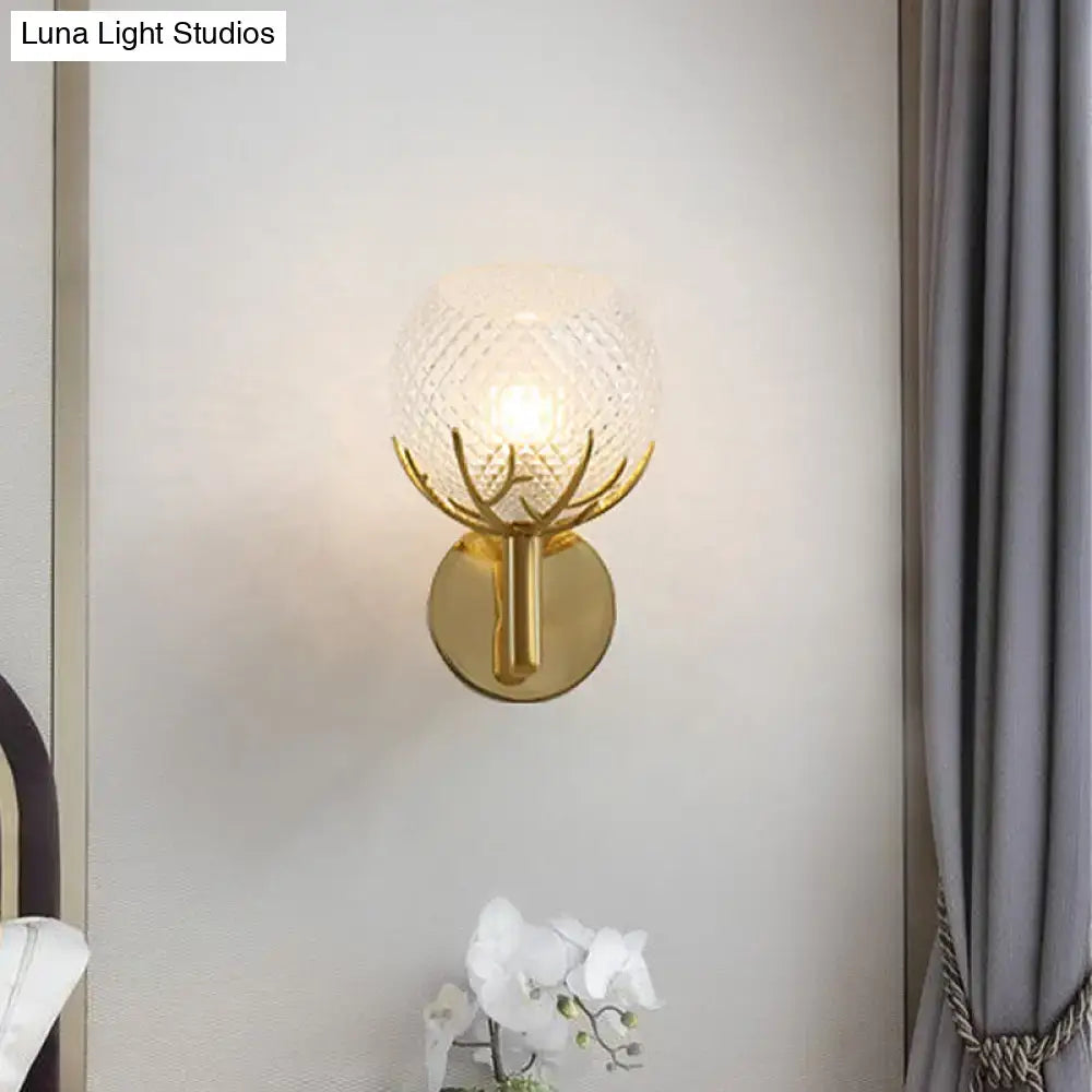 Modern 1-light gold wall sconce with antler design and clear latticed glass globe for bedroom lighting decor