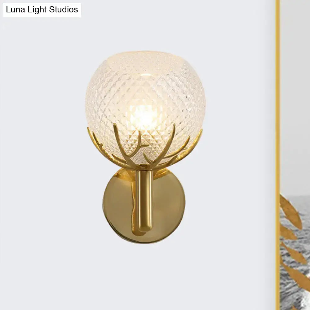 Modern 1-light gold wall sconce with antler design metal arms and textured frosted globe with clear latticed glass
