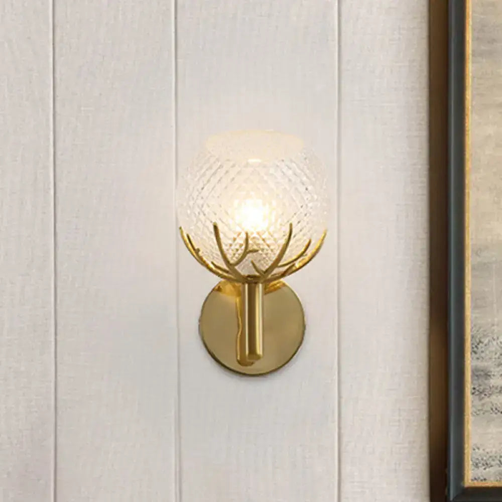 Modern 1-light gold wall sconce with antler design and clear latticed glass globe for bedroom lighting