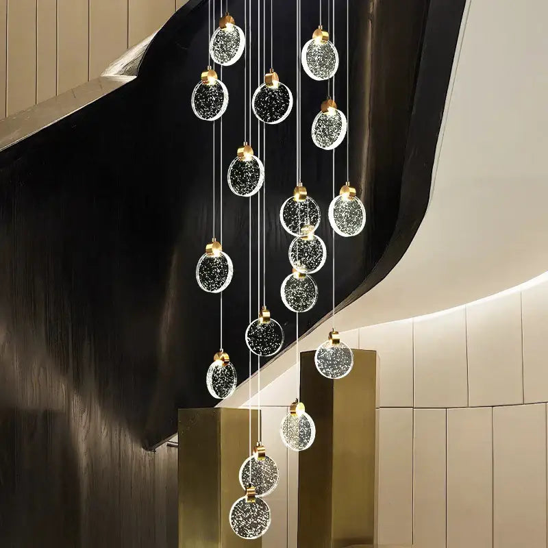 Modern gold attic crystal chandelier with glass orbs embedded with sparkling particles for dining room lighting