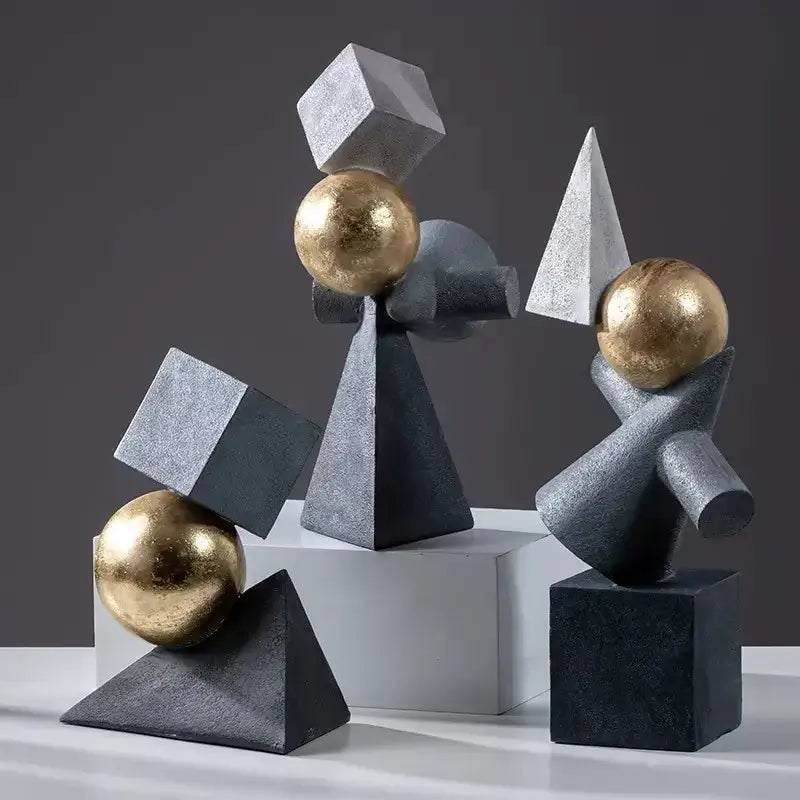 Modern gold ball triangular statues featuring matte black and metallic gold spheres on gray concrete bases perfect for living room decorbites geometric gold design