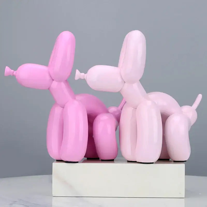 Modern gold balloon dog statue featuring pink resin balloon dog figurines on a white base for living room decor