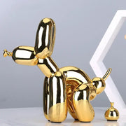 Modern gold balloon dog statue with shiny reflective surface in resin art sculpture for living room decor