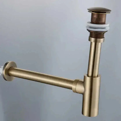 Brass-colored modern gold basin tap kit drain pipe with cylindrical stopper and white rubber seal for bathroom use
