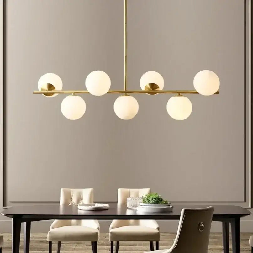 Modern gold bean glass chandelier with six frosted globe lights ideal for dining room or living room lighting