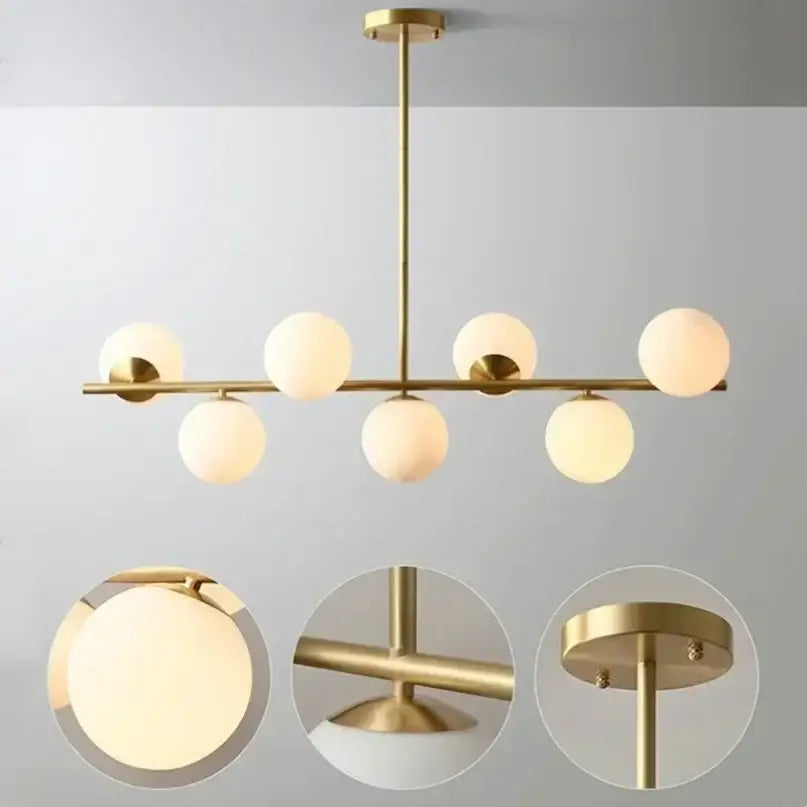Modern gold bean glass chandelier with brass finish and six frosted globes for dining room or living room lighting