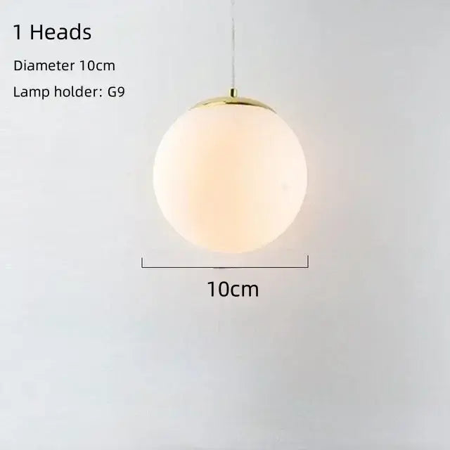 A sleek 10cm frosted glass globe pendant lamp with polished brass fixture for modern gold bean glass chandelier lighting