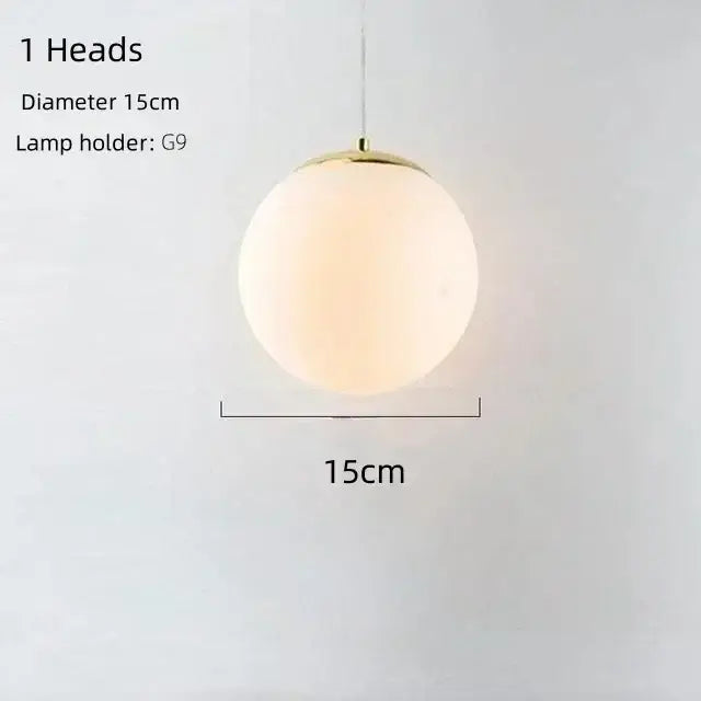 A sleek modern gold bean glass chandelier pendant light with frosted globe and polished brass fixture for living room
