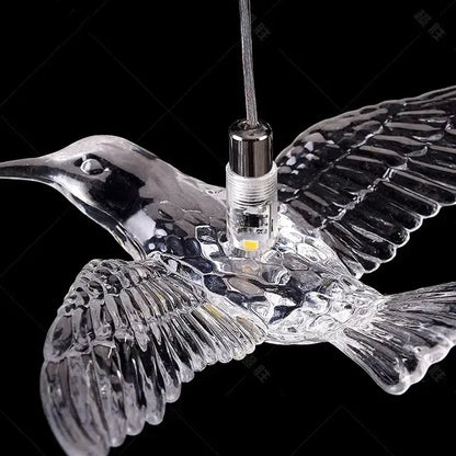 Modern gold bird design led chandelier with clear glass hummingbird pendant light and intricate wing detailing for living room decorbites bird design