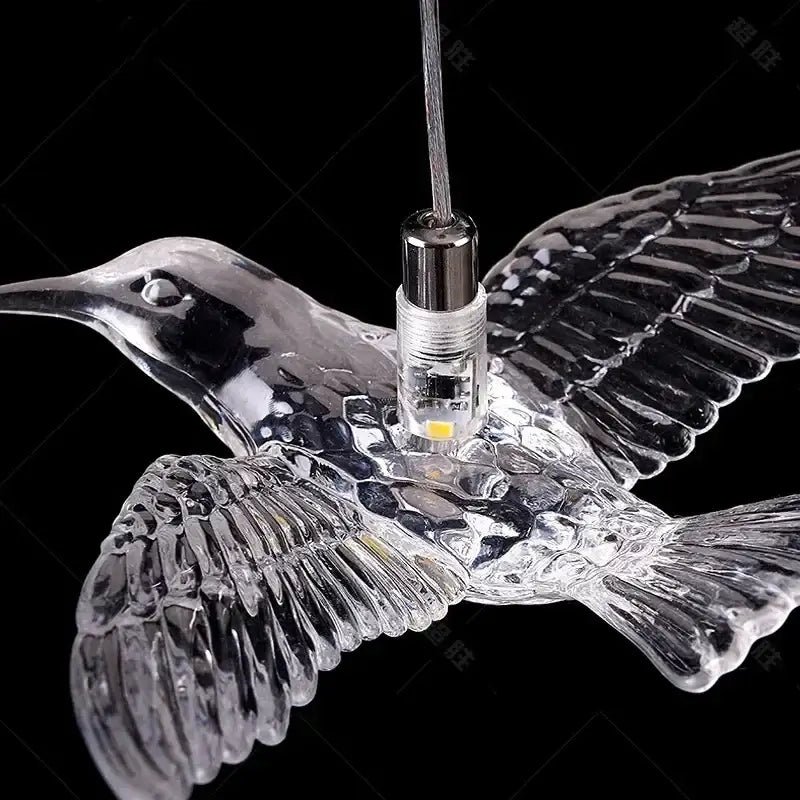 Modern gold bird design led chandelier with clear glass hummingbird pendant light and intricate wing detailing for living room decorbites bird design