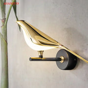 Modern gold bird led wall lamp with sleek reflective finish and black mounting base for bedroom decor wall lamp