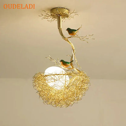 Modern gold-toned metal pendant lights with bird-themed nest glass design featuring green and orange birds for dining room
