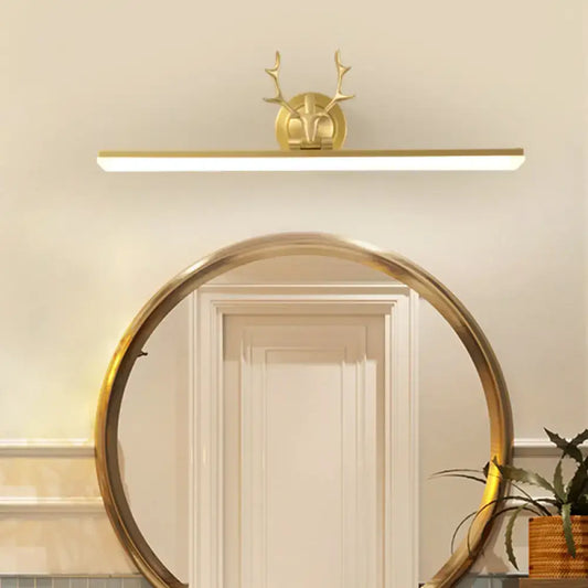 Modern gold and black antler vanity sconce light with a gold-toned deer head design and antlers for bedroom use