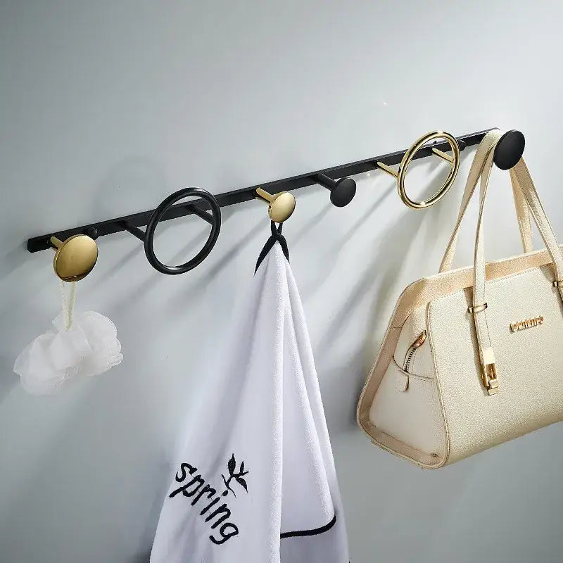 Black and gold brass towel hook set with round and circular hooks for modern bathroom wall hanging