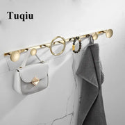 Modern gold and black brass towel hook set featuring gold-toned tuqiu wall-mounted hooks with sleek circular design