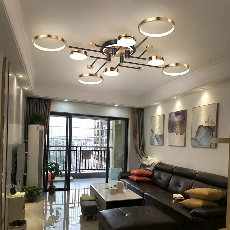 Modern gold black pendant light featuring multiple circular rings and a central hub design for living room decorbites gold black