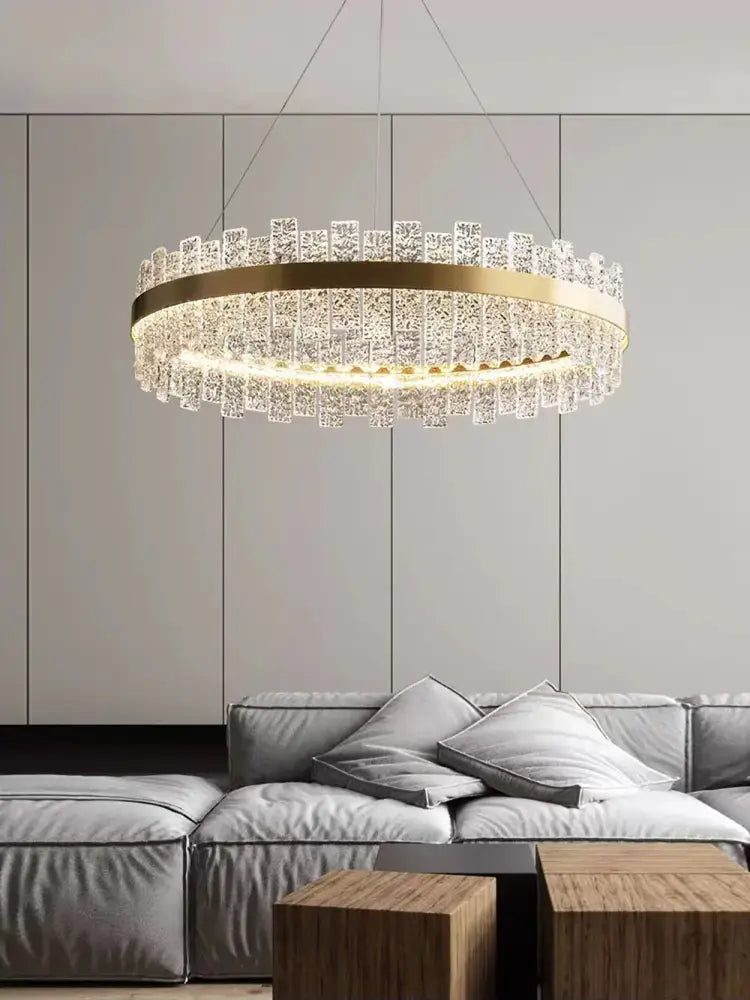 A modern gold and black crystal led chandelier with a circular frame and cascading clear prisms by decorbites crystal led