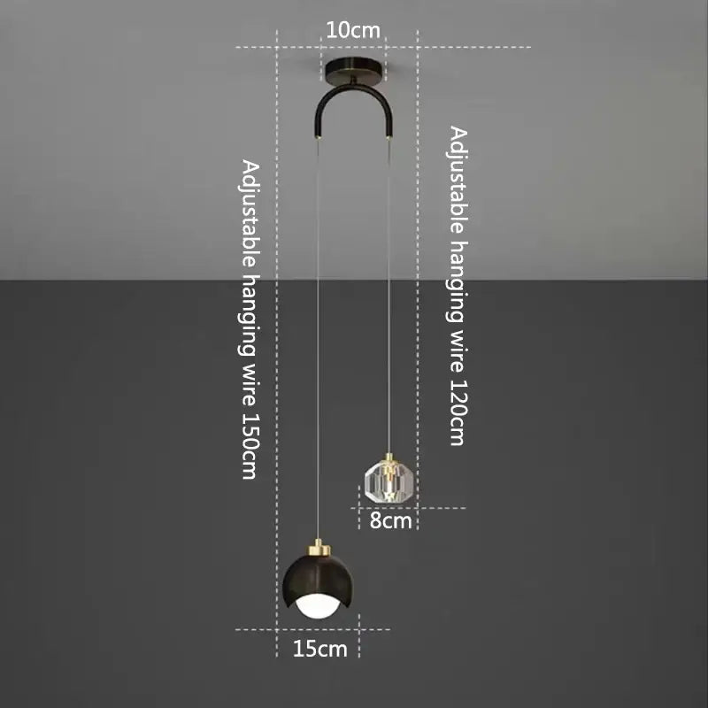 Modern gold and black linear pendant light with spherical glass shade ideal for dining room lighting