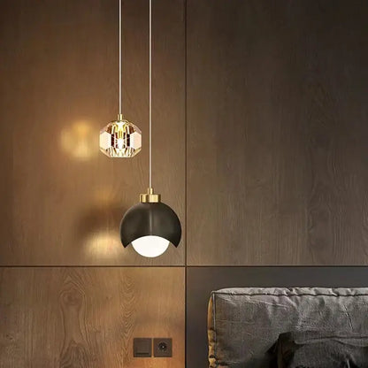 Two modern linear pendant lights feature a gold crystal faceted design and a sleek black dome pendant light for dining room