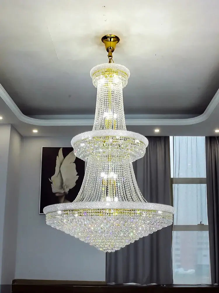 Modern gold and black pendant light with metal finish and cascading crystal tiers for staircase or dining room use