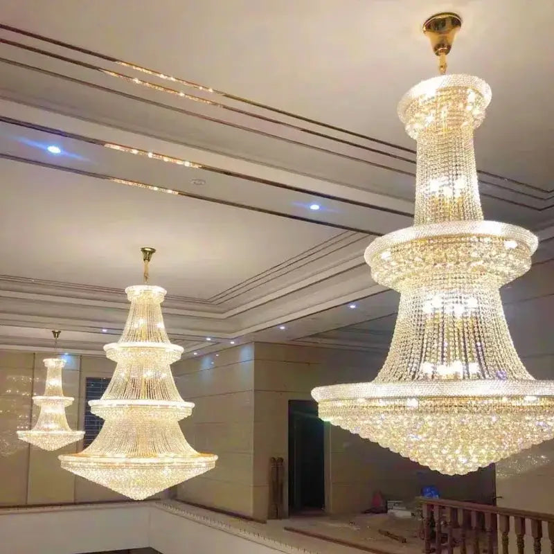 Modern gold and black pendant light with metal finish and cascading crystal tiers for dining room staircase