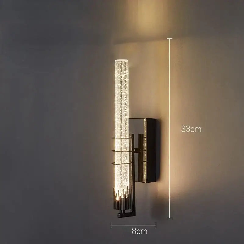 Modern gold and black crystal wall sconce with textured clear glass cylinder and metallic frame for bedroom decorbites crystal wall lighting