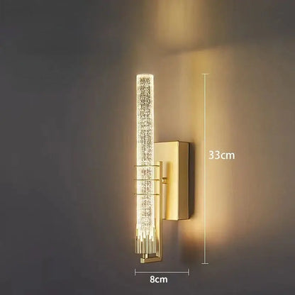 Modern gold and black crystal wall sconce with vertical crystal-encrusted cylindrical light and rectangular backplate decorbites crystal wall