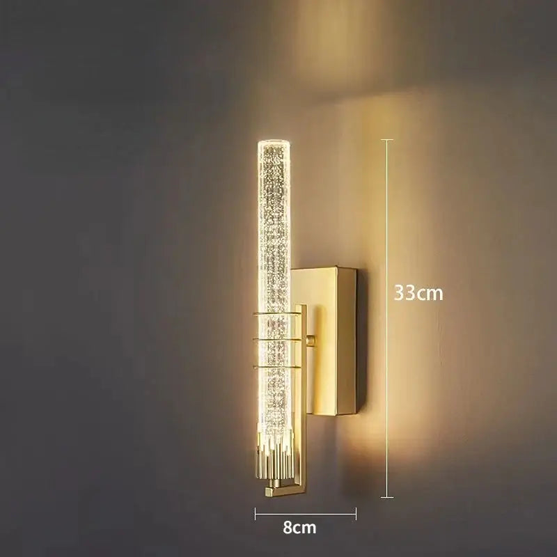 Modern gold and black crystal wall sconce with vertical crystal-encrusted cylindrical light and rectangular backplate decorbites crystal wall