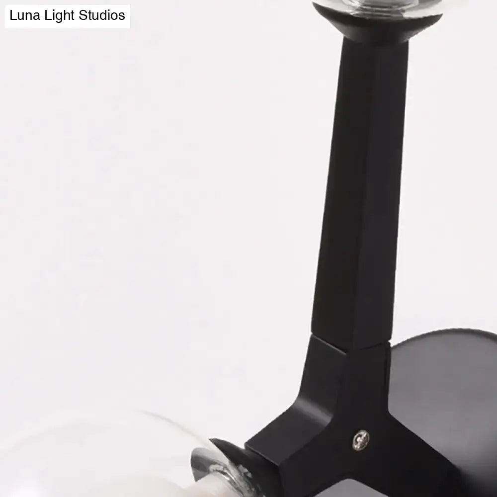 Modern gold and black double globe wall lamp featuring a black matte metal arm with a clear glass bulb globe wall lamp