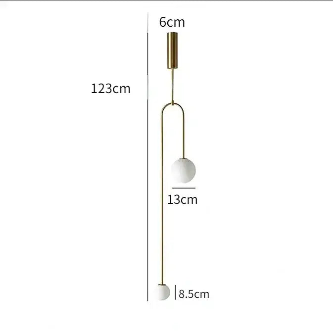 Modern gold and black glass globe pendant light with slender brass metal detailing for dining room lighting