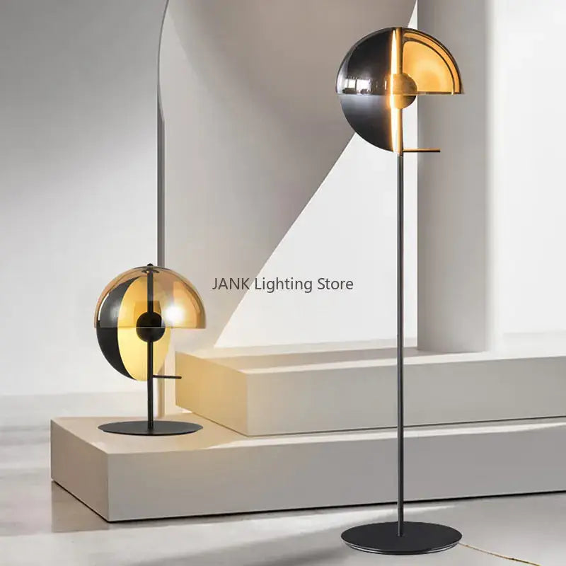 Modern gold and black glass hemisphere led floor lamp with sleek black metal stand and striking gold mirrored shade