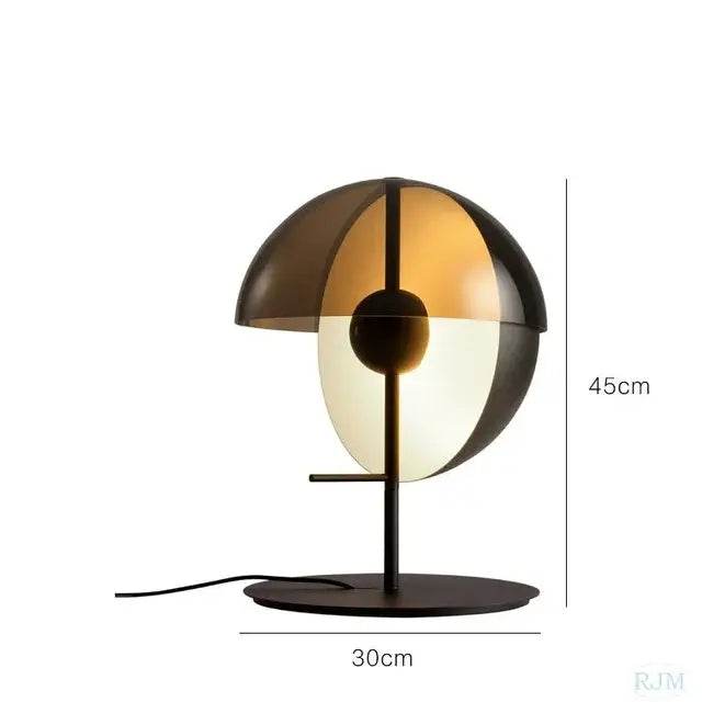 Modern gold and black floor lamp with a glass hemisphere led shade featuring translucent amber and opaque white halves