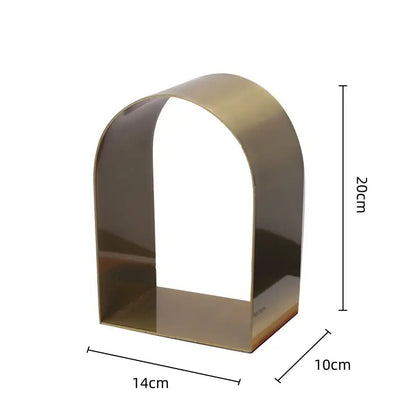 A sleek modern gold and black golden arches metal sculpture bookend with polished brass finish for living room decorbites