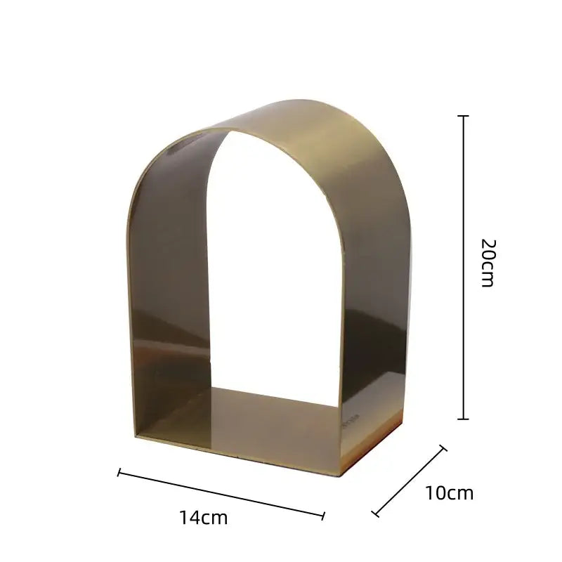 A sleek modern gold and black golden arches metal sculpture bookend with polished brass finish for living room decorbites