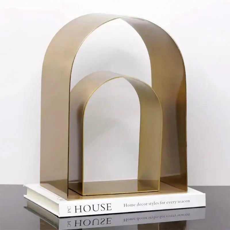 Modern gold and black golden arches metal sculpture bookend in gold-toned metal with sleek minimalist design