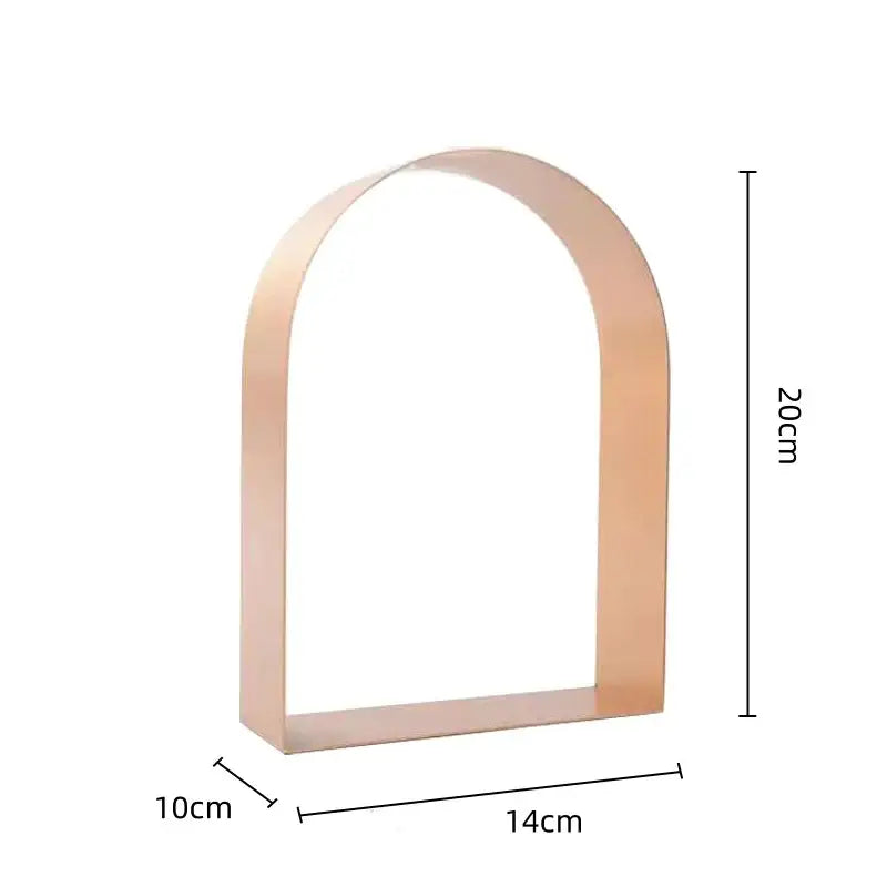 A sleek rose gold metal sculpture modern gold and black decorbites golden arches bookend with minimalist design