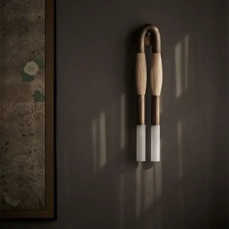 Modern gold and black decorbites horsehair wall lamp with light-toned wood arms and frosted glass shades wall lamp