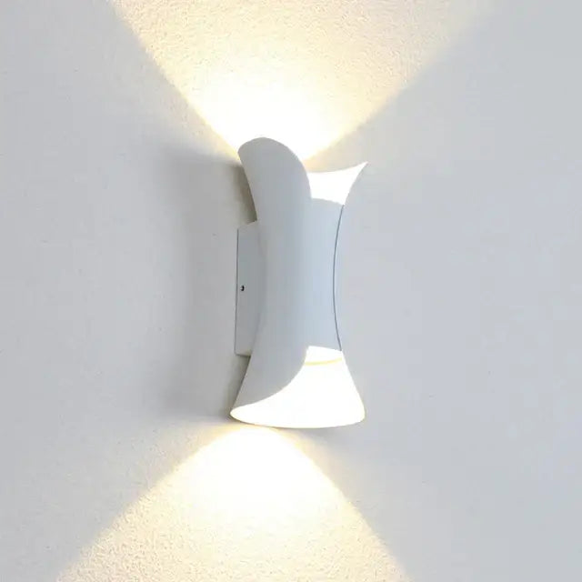 Modern gold and black decorbites led wall light with sleek curved white sconce casting warm light for garden decor