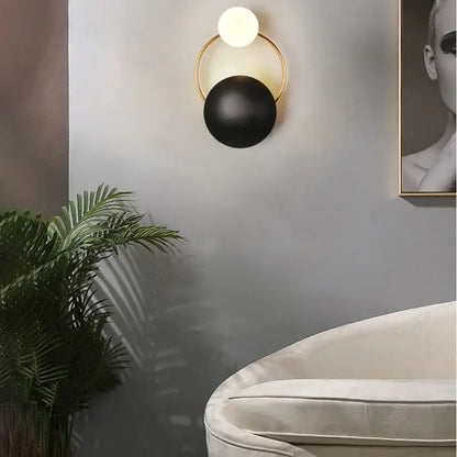 Modern gold and black elegant led wall sconce with a circular frame and two spherical bulbs for living room decorbites light