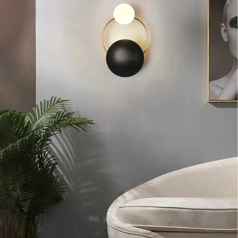 Modern gold and black elegant led wall sconce with a circular frame and two spherical bulbs for living room decorbites light