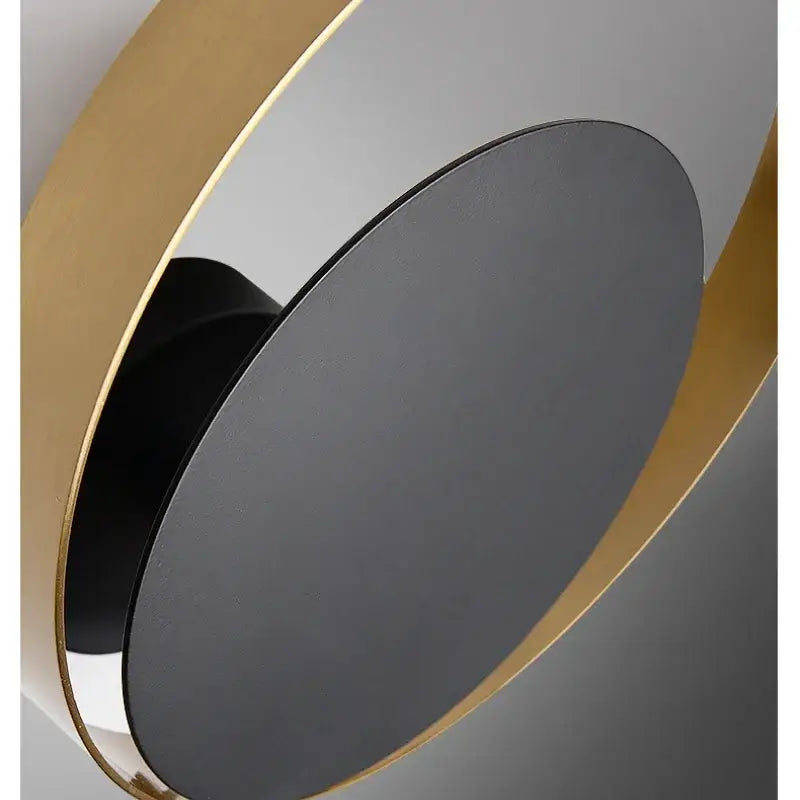 Modern gold and black wall sconce with sleek black matte disc and polished gold rings perfect for elegant led wall decorbites light